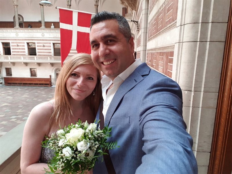 Our wedding day at Copenhagen City Hall with Danish flag